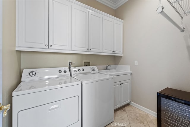 clothes washing area featuring cabinets, ornamental molding, sink, washer and dryer, and wine cooler