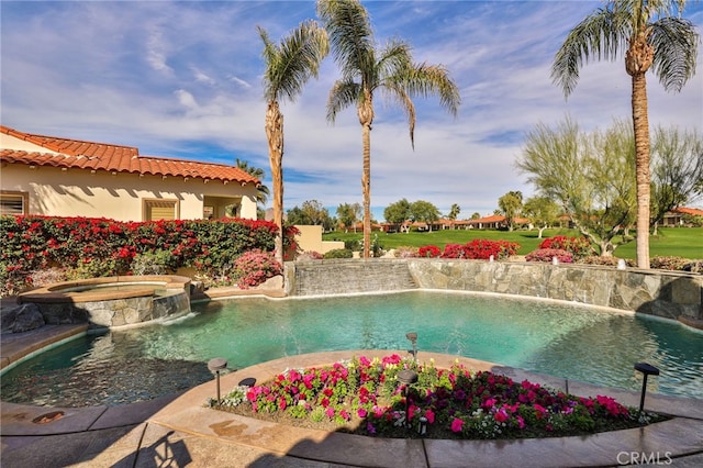 view of swimming pool featuring an in ground hot tub and pool water feature