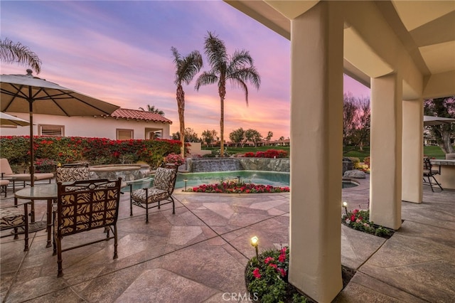 view of patio terrace at dusk