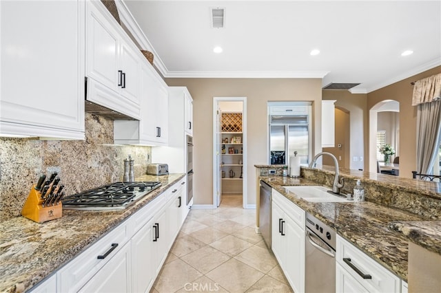 kitchen featuring white cabinets, premium range hood, sink, and appliances with stainless steel finishes