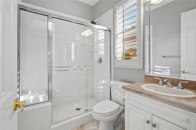 bathroom featuring tile patterned floors, vanity, toilet, and walk in shower