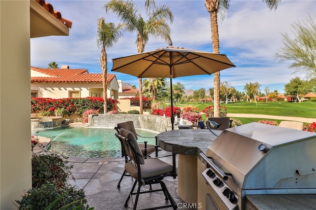 view of patio with area for grilling, a grill, and pool water feature