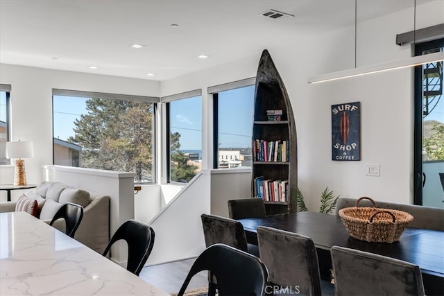 dining space with light hardwood / wood-style floors