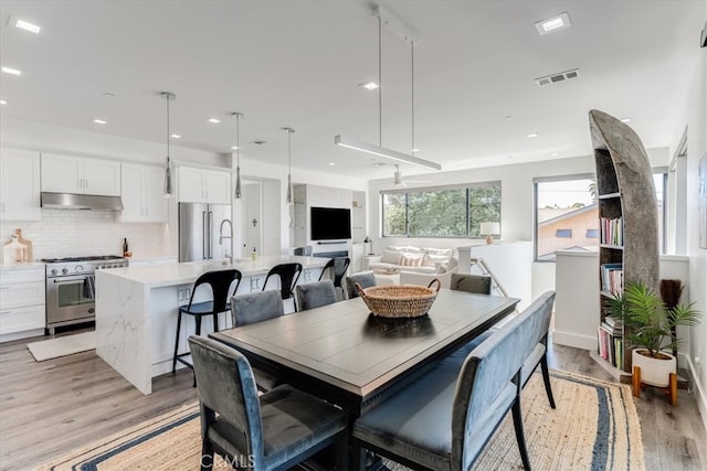 dining area featuring light wood-type flooring