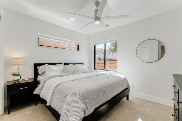 bedroom with ceiling fan and light colored carpet