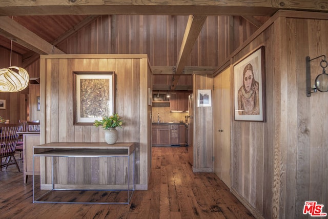 interior space featuring vaulted ceiling with beams, wood walls, wood ceiling, and hardwood / wood-style flooring