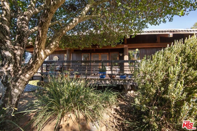 rear view of house featuring a deck