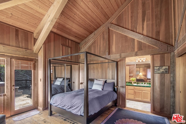 bedroom with ensuite bath, wooden ceiling, high vaulted ceiling, wooden walls, and hardwood / wood-style flooring