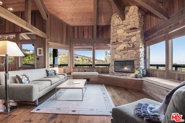 living room featuring hardwood / wood-style flooring, high vaulted ceiling, and a healthy amount of sunlight