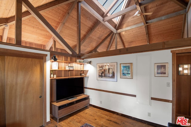 unfurnished living room featuring light wood-type flooring, wood ceiling, wooden walls, beam ceiling, and high vaulted ceiling