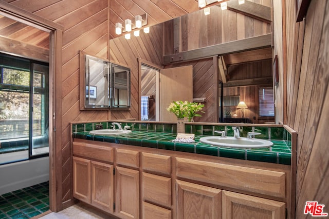 bathroom with vanity and wood walls