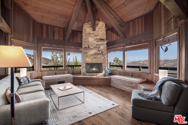 living room featuring wood ceiling, a mountain view, wood-type flooring, and high vaulted ceiling