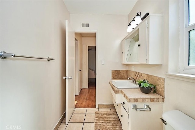 bathroom featuring toilet, vanity, and tile patterned floors