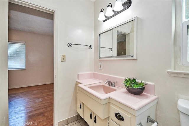 bathroom with vanity, wood-type flooring, and toilet