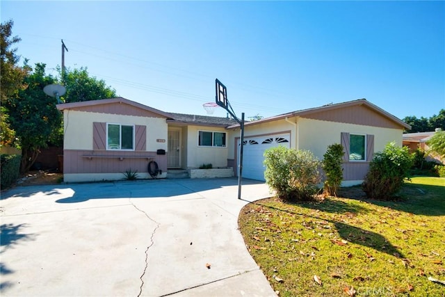 single story home featuring a garage and a front lawn