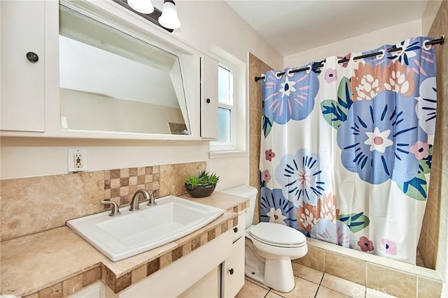 bathroom with a shower with shower curtain, vanity, tile patterned floors, and toilet