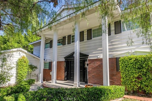 rear view of house featuring a porch