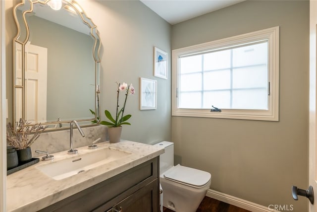 bathroom featuring hardwood / wood-style flooring, vanity, and toilet