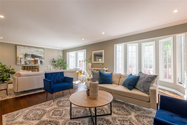 living room with plenty of natural light, dark hardwood / wood-style flooring, and ornamental molding