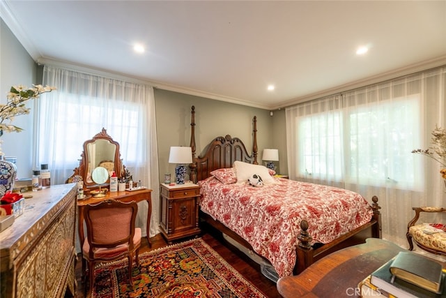 bedroom featuring dark hardwood / wood-style floors, ornamental molding, and multiple windows