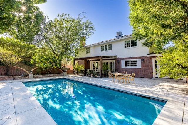 view of pool with a patio area and central AC