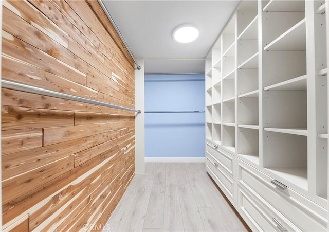 walk in closet with light wood-type flooring