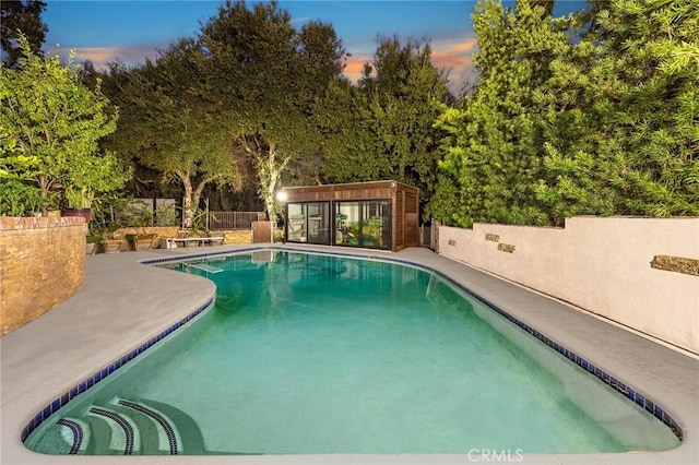 view of pool at dusk