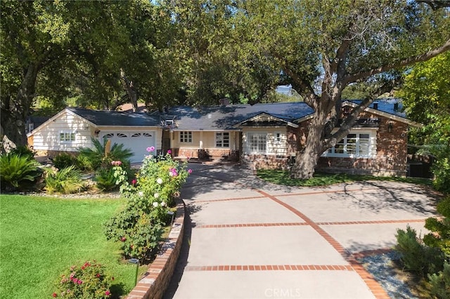 ranch-style house with a front yard and a garage