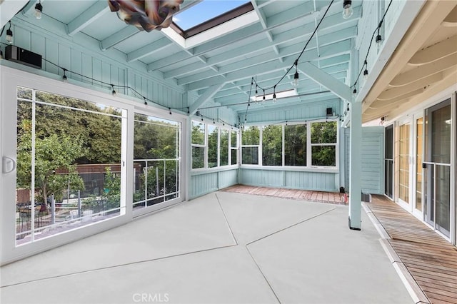 unfurnished sunroom featuring a skylight and a wealth of natural light