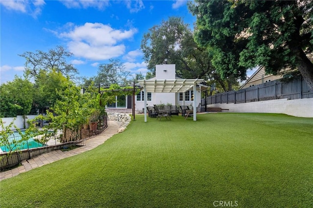 back of house with a yard, a pergola, and a pool