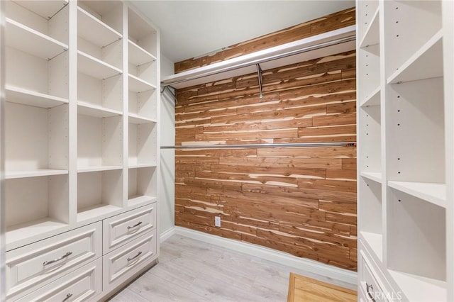 spacious closet featuring light hardwood / wood-style floors