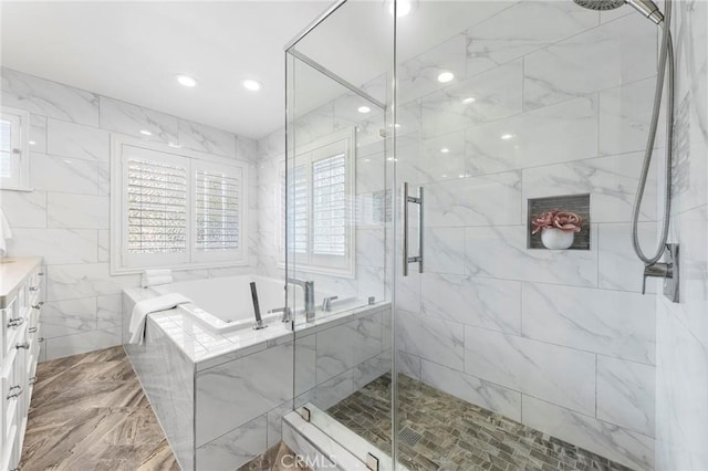 bathroom featuring vanity and separate shower and tub