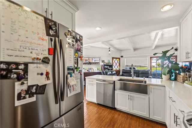 kitchen featuring white cabinetry, appliances with stainless steel finishes, sink, and dark wood-type flooring