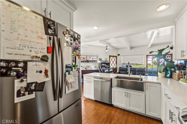 kitchen with appliances with stainless steel finishes, light countertops, and white cabinetry