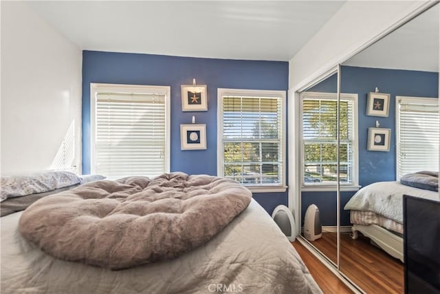 bedroom with baseboards and dark wood finished floors