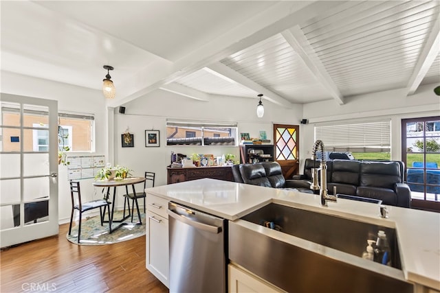 kitchen featuring sink, dishwasher, decorative light fixtures, white cabinets, and light hardwood / wood-style flooring