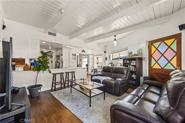 living room featuring beam ceiling and dark hardwood / wood-style flooring