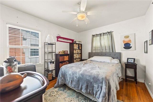 bedroom featuring hardwood / wood-style flooring and ceiling fan