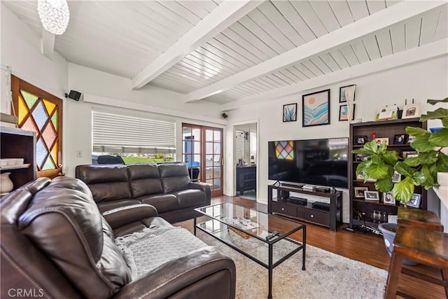 living area featuring beamed ceiling and wood finished floors