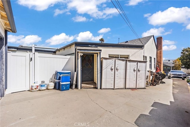 view of outbuilding featuring fence