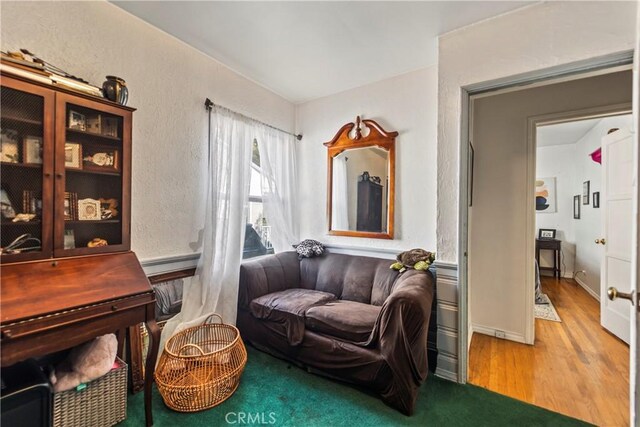 sitting room with wood-type flooring