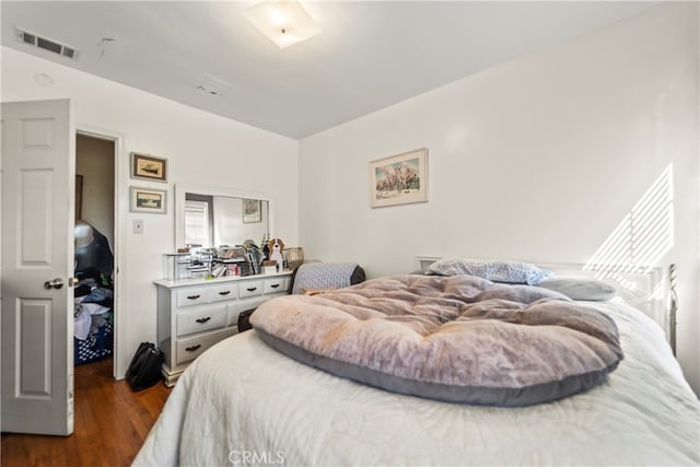 bedroom with dark hardwood / wood-style flooring