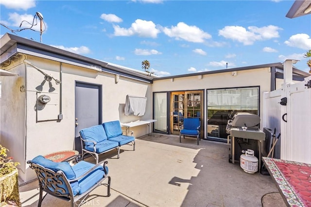 view of patio / terrace featuring a grill, an outdoor living space, and fence