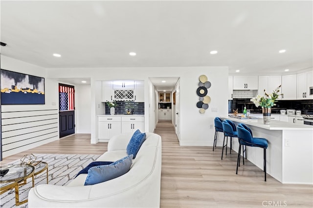 living room featuring light hardwood / wood-style floors and a brick fireplace