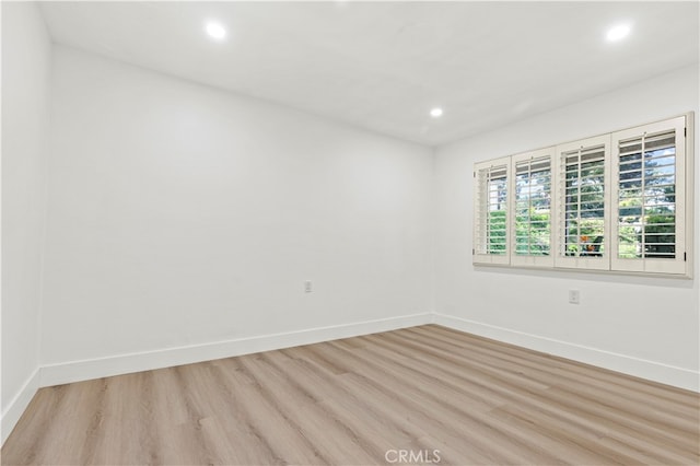 unfurnished room with light hardwood / wood-style flooring