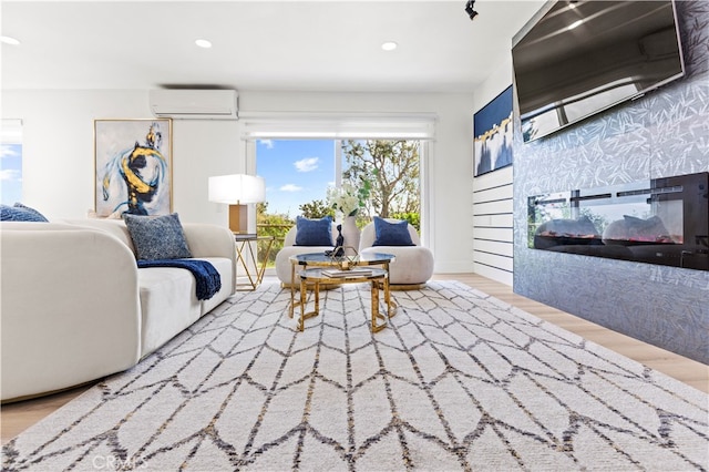 living room with a multi sided fireplace, hardwood / wood-style floors, and an AC wall unit