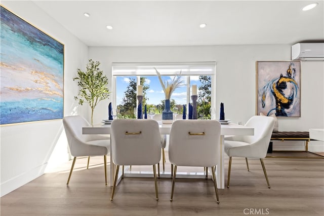 dining area featuring a wall mounted AC and hardwood / wood-style floors