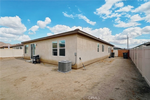 back of house with a patio area and central AC unit