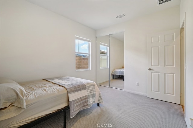 carpeted bedroom featuring a closet