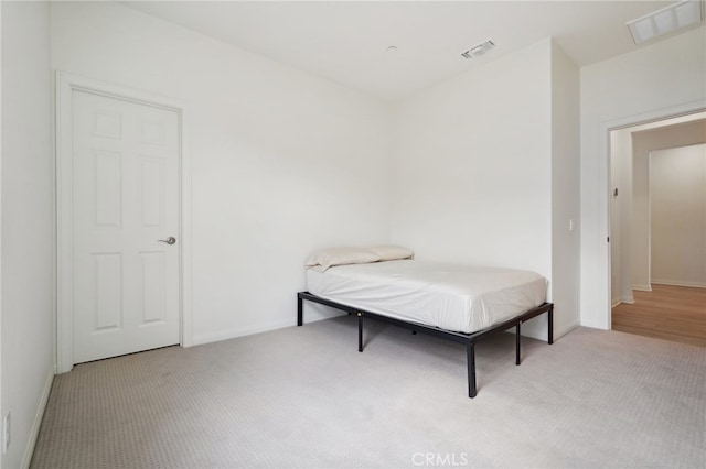 bedroom featuring light carpet